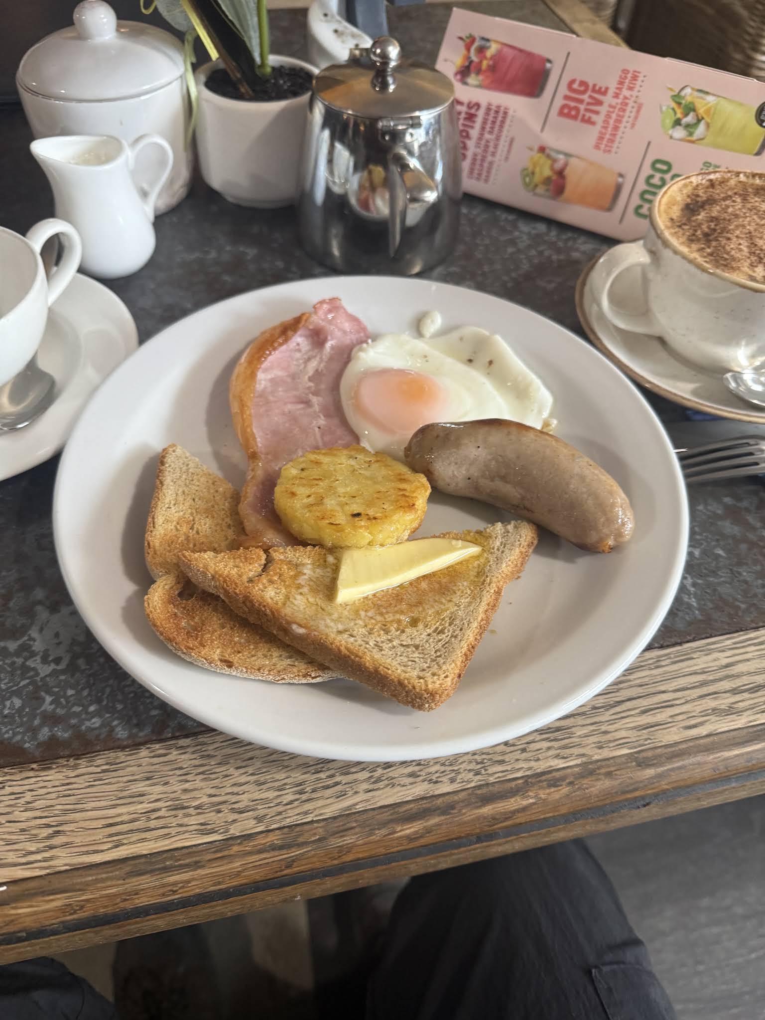 A whole white breakfast plate photographed at Utopia, with toast, egg and breakfast accompaniments